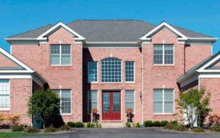 Large Mississauga house featuring modern double-pane windows and red entry door.