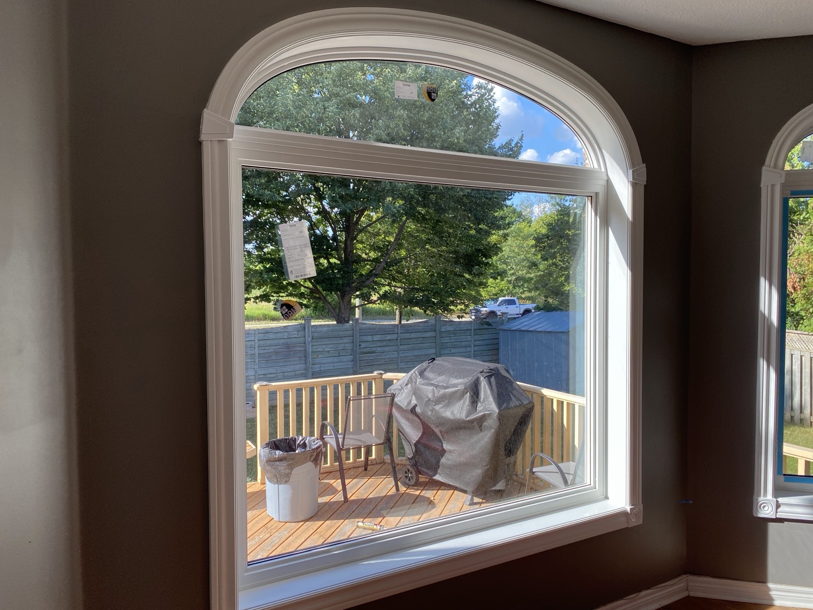 Arched window seen from inside a living room installed by Optima Windows and Doors in the Greater Toronto Area