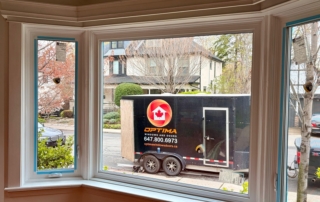 Bay window replacement seen from inside, with the Optima installation trailer parked outside installed by Optima Windows and Doors in the Greater Toronto Area
