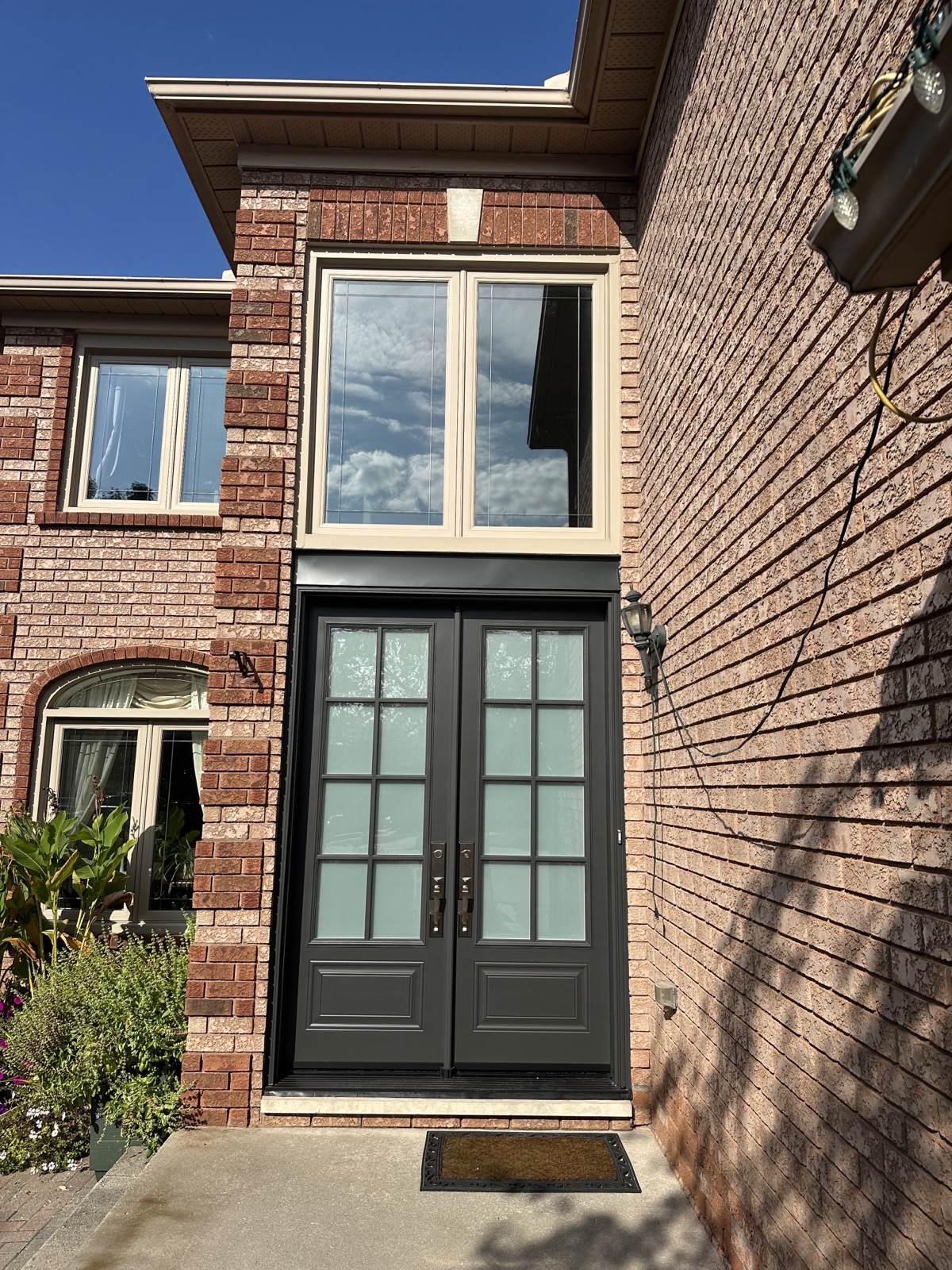 Black casement windows on a brick home installed by Optima Windows and Doors in the Greater Toronto Area