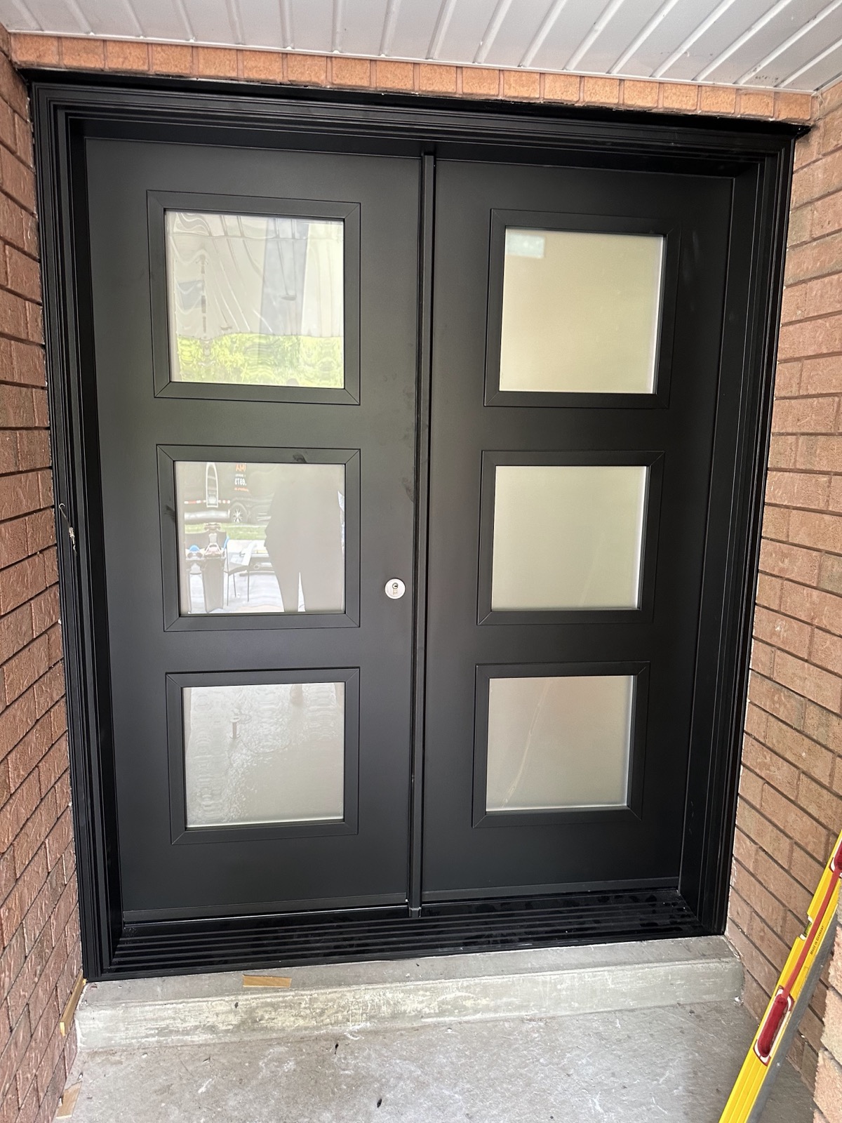 Contemporary double entry doors with frosted glass installed by Optima Windows and Doors in the Greater Toronto Area