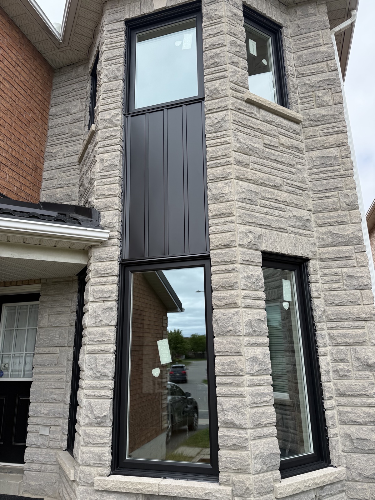 Contemporary home with tall black framed windows installed by Optima Windows and Doors in the Greater Toronto Area