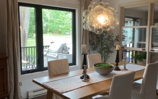 Dining room with black framed windows and patio doors installed by Optima Windows and Doors in the Greater Toronto Area