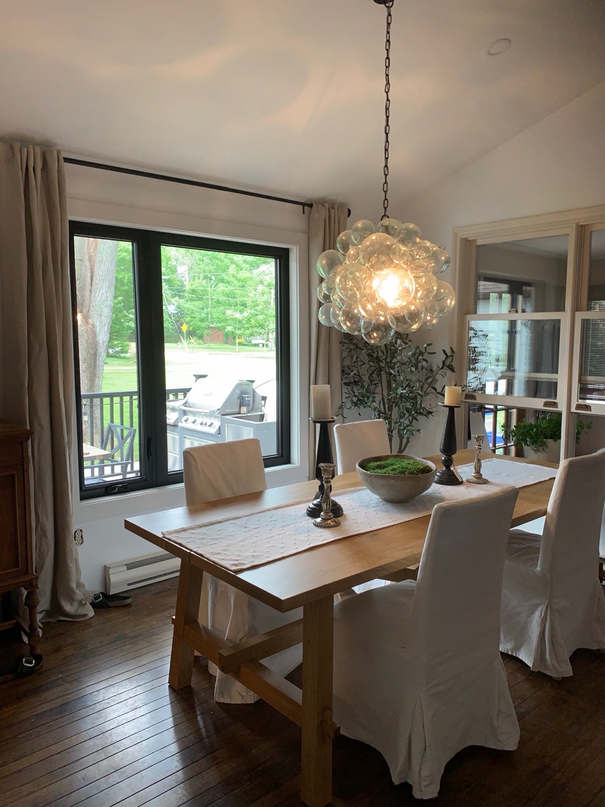 Dining room with black framed windows and patio doors installed by Optima Windows and Doors in the Greater Toronto Area