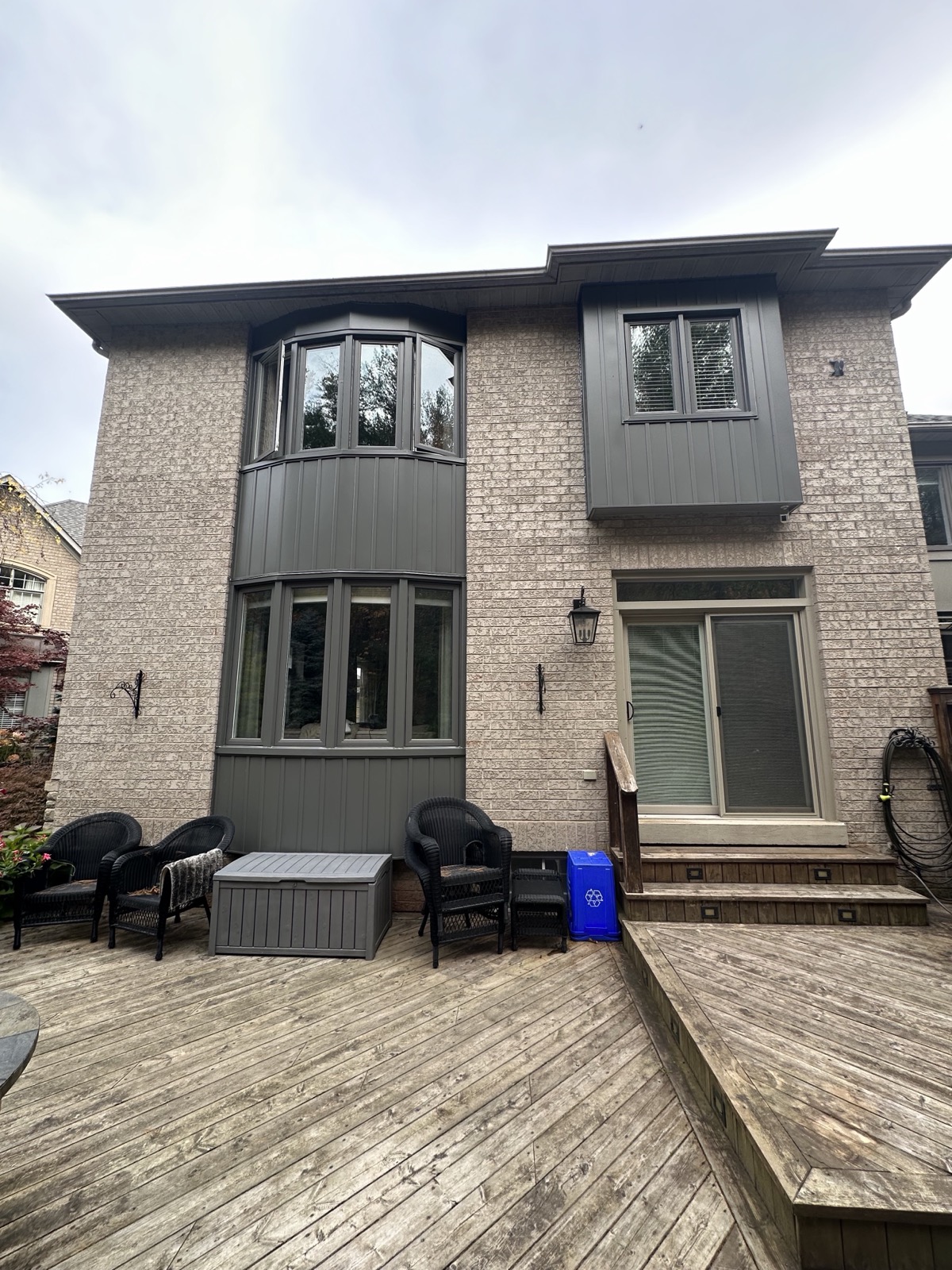 Grey brick home with black framed windows installed by Optima Windows and Doors in the Greater Toronto Area