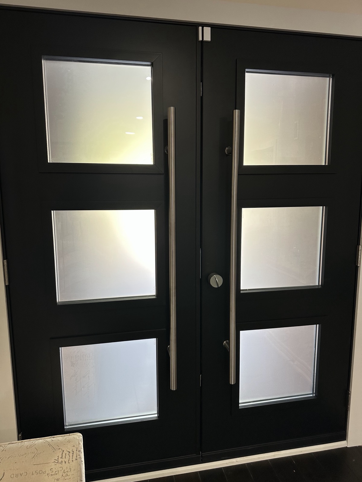 Modern black double doors with frosted glass panels installed by Optima Windows and Doors in the Greater Toronto Area