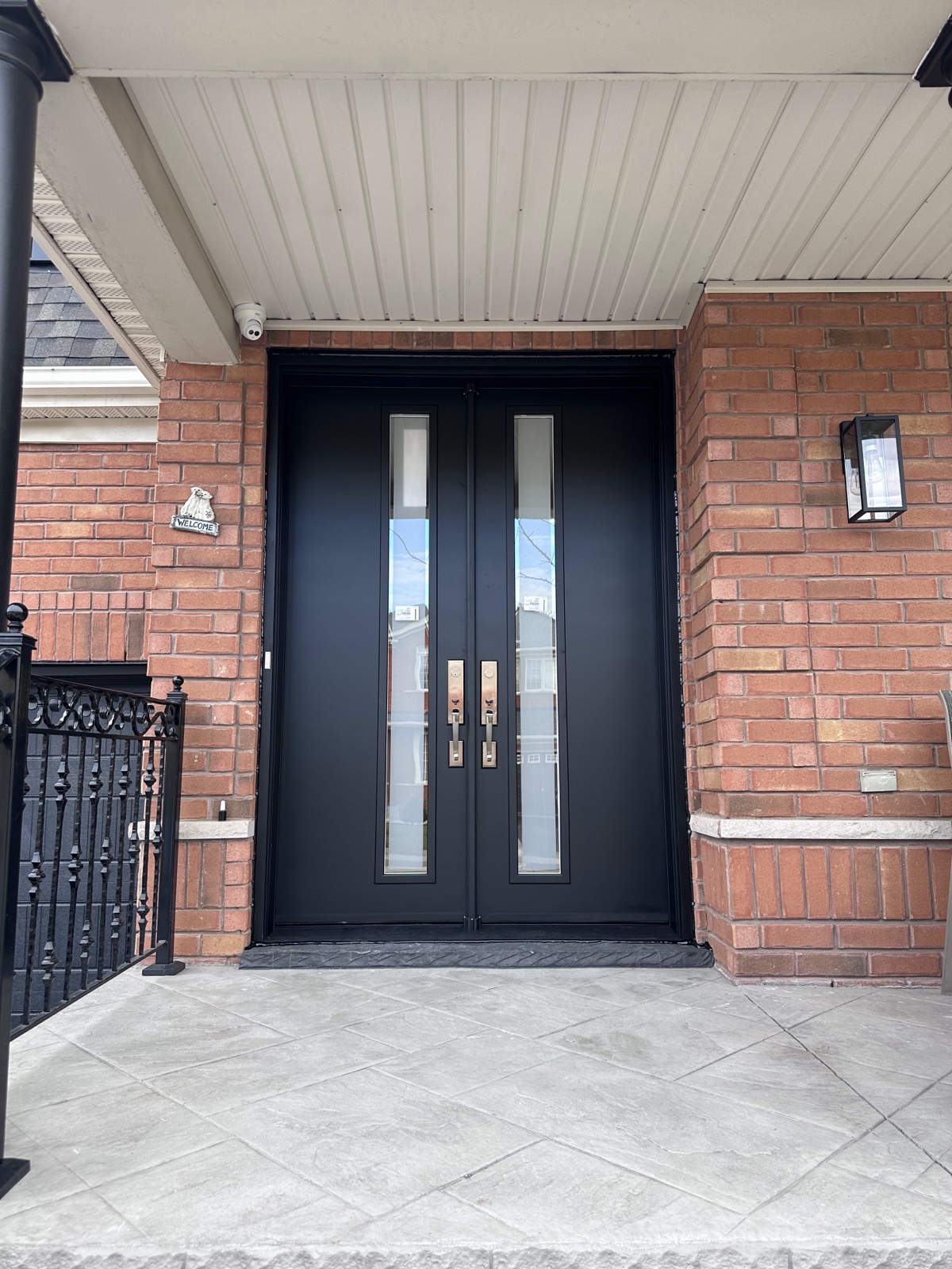 Modern black double entry doors with vertical glass installed by Optima Windows and Doors in the Greater Toronto Area