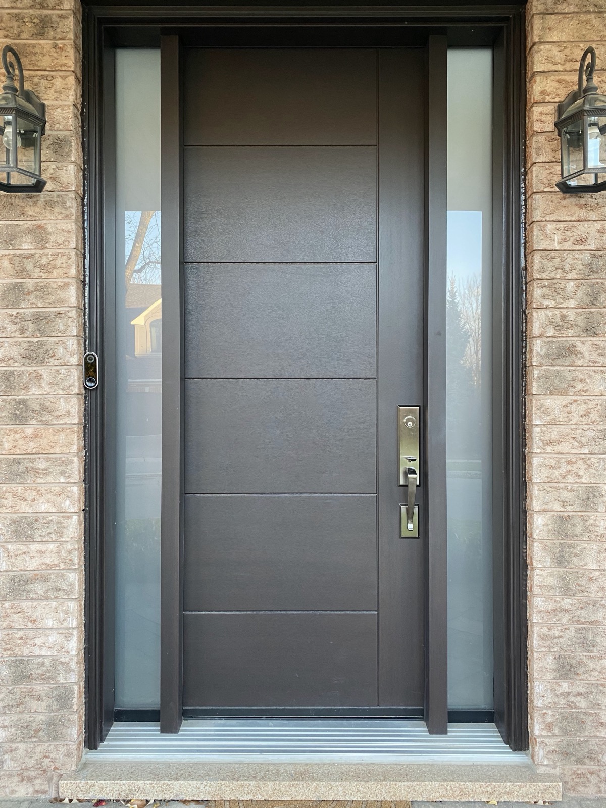 Modern entry door with a long pull handle installed by Optima Windows and Doors in the Greater Toronto Area