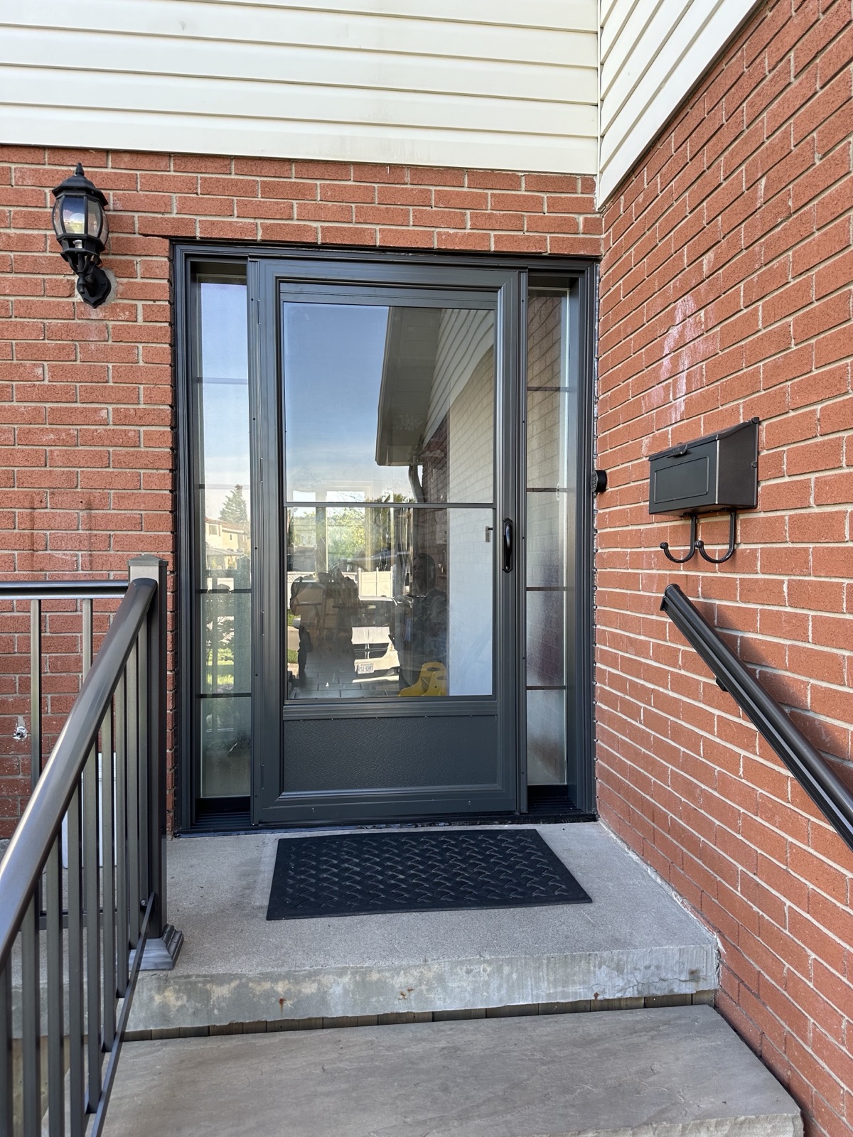 New entry door open on installation day at a brick home installed by Optima Windows and Doors in the Greater Toronto Area