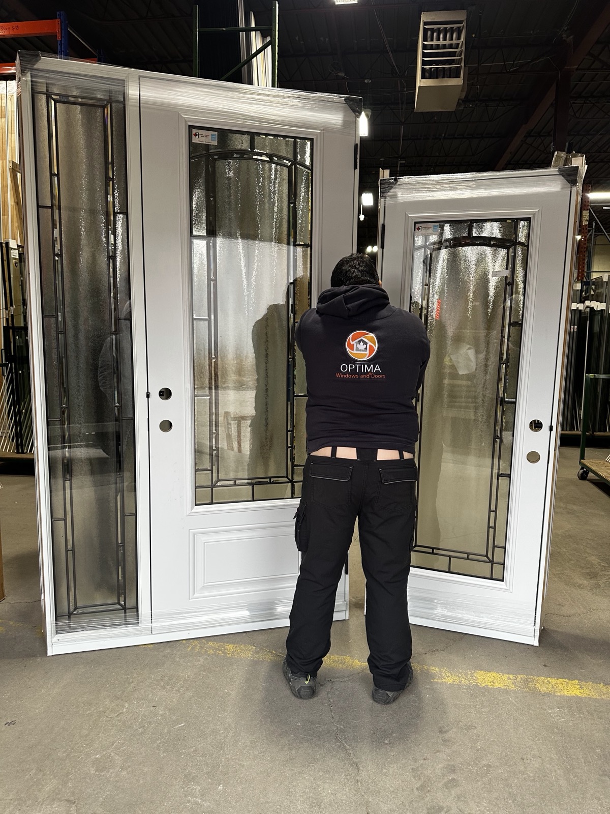 Optima team member carrying a new entry door on installation day installed by Optima Windows and Doors in the Greater Toronto Area