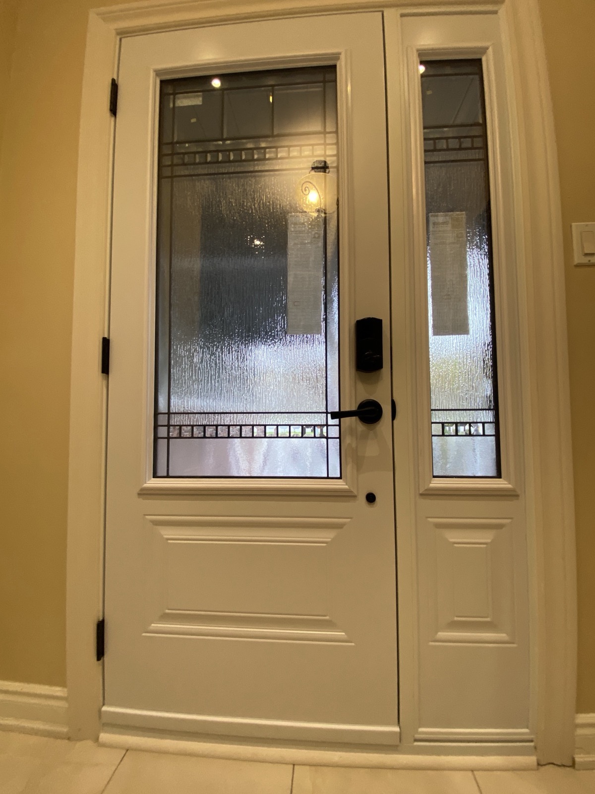 Warm toned entry door with decorative glass installed by Optima Windows and Doors in the Greater Toronto Area