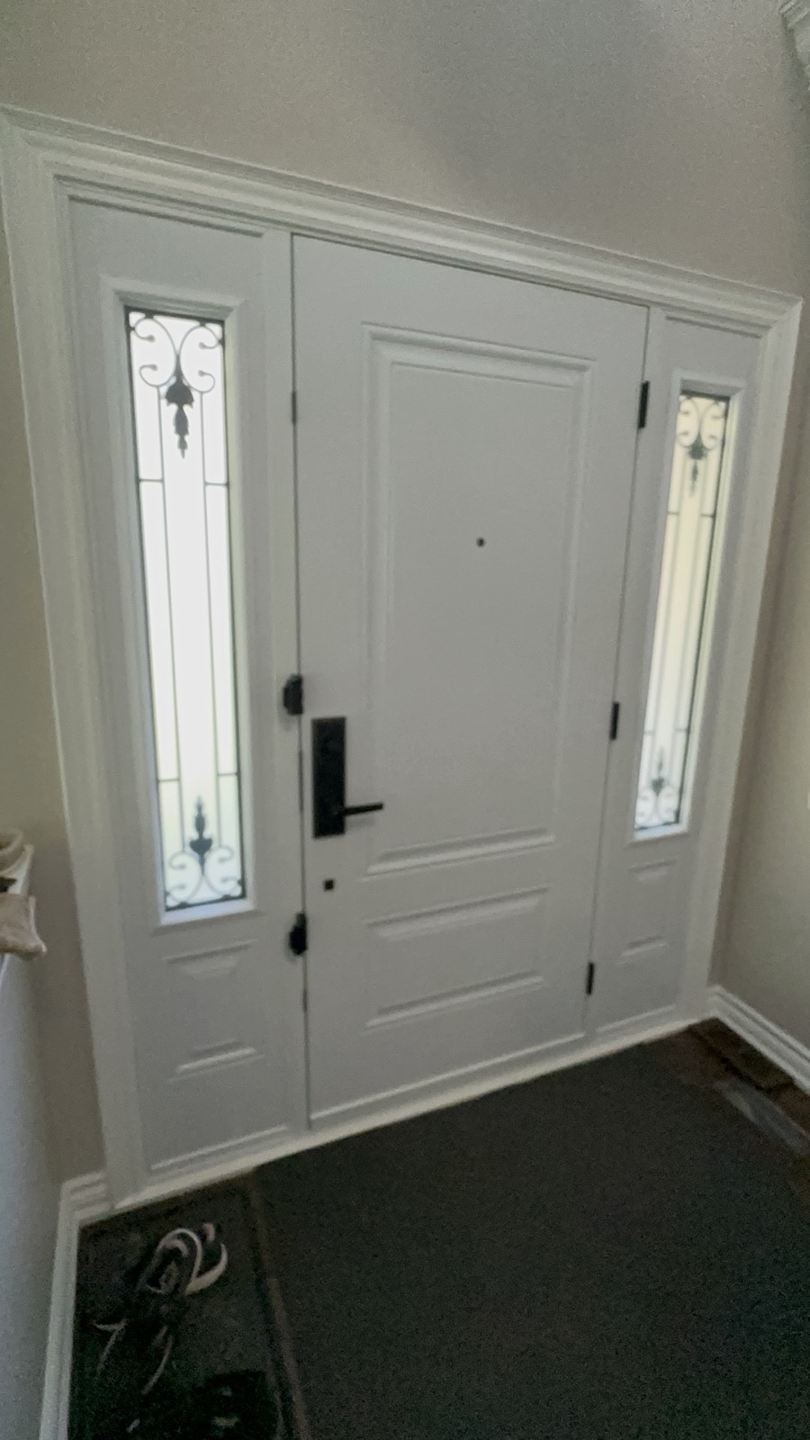 White entry door with a decorative glass insert installed by Optima Windows and Doors in the Greater Toronto Area