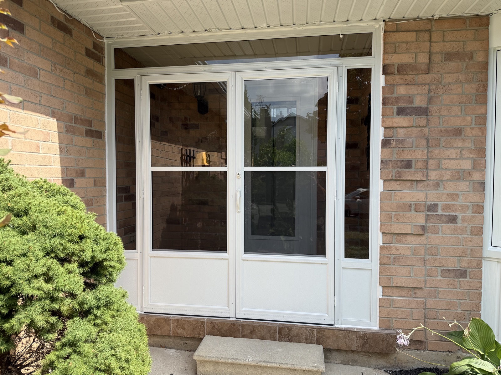 White patio door and surrounding windows installed by Optima Windows and Doors in the Greater Toronto Area