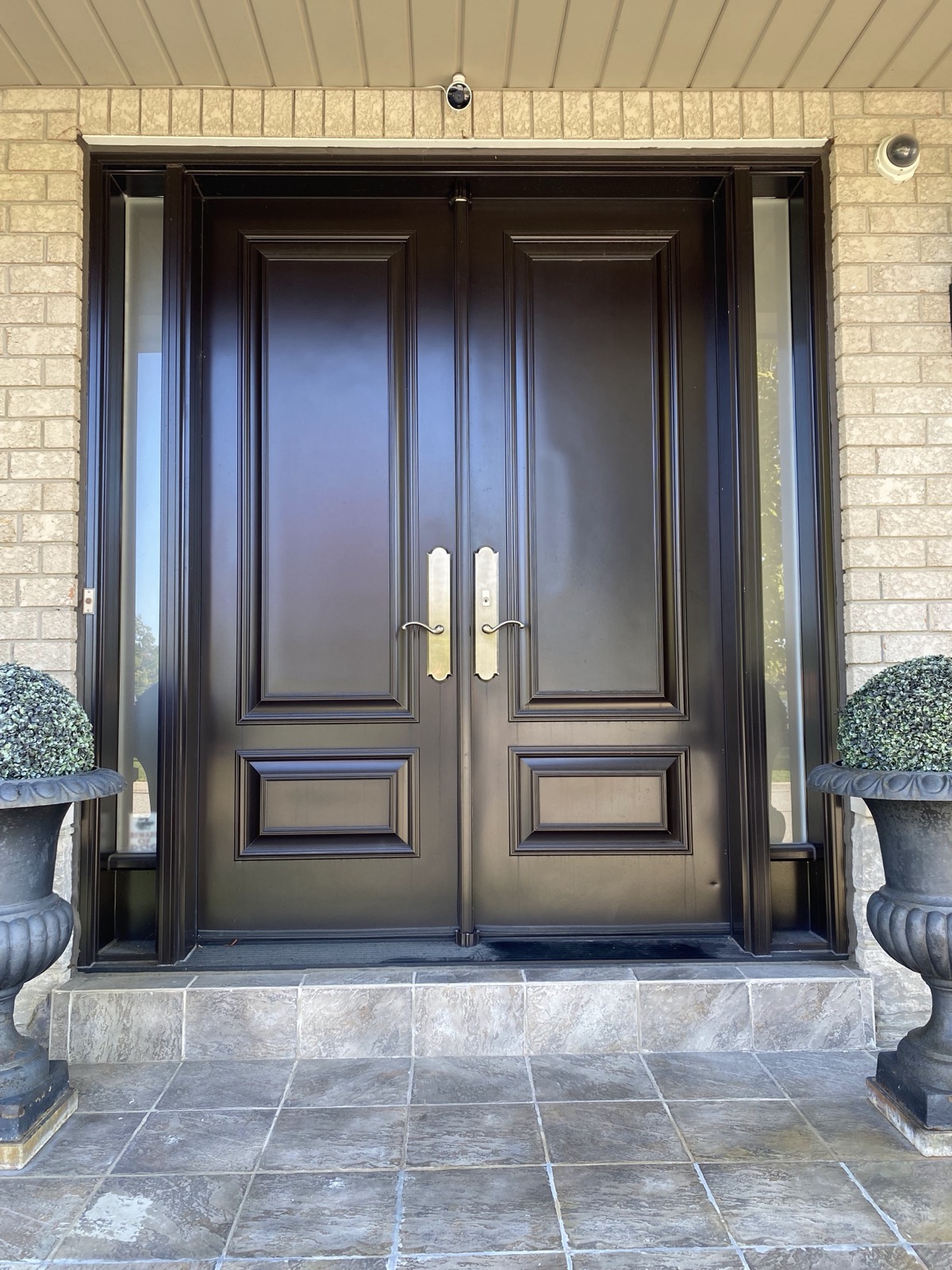 Wood finish double entry doors with glass inserts installed by Optima Windows and Doors in the Greater Toronto Area